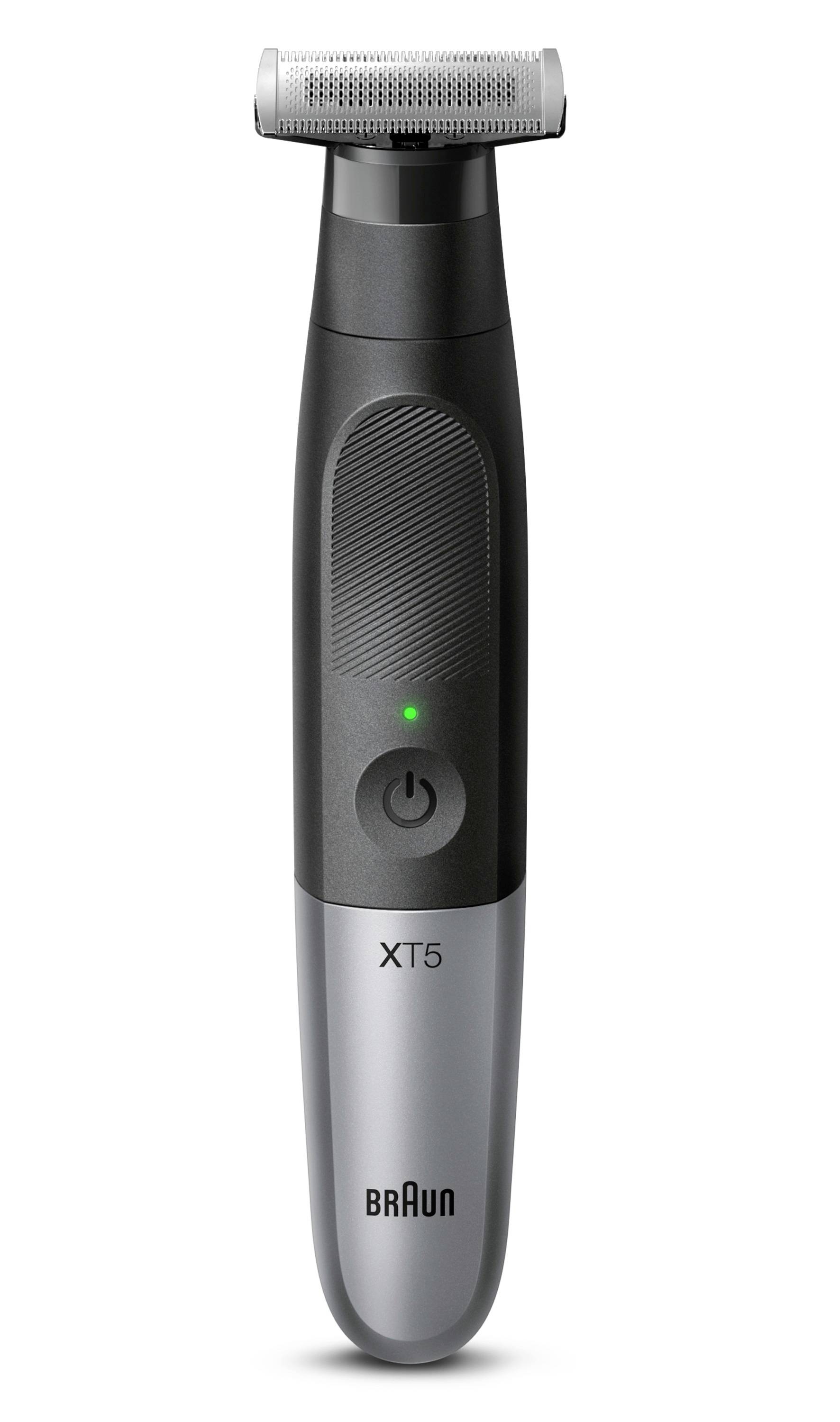 Braun XT5 electric trimmer with illuminated power button on a white background.