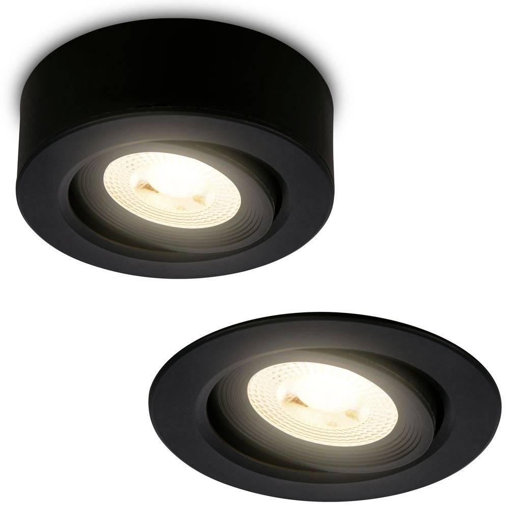 Deux spots encastrés de plafond noirs avec ampoules LED allumées, présentés sur un fond blanc.