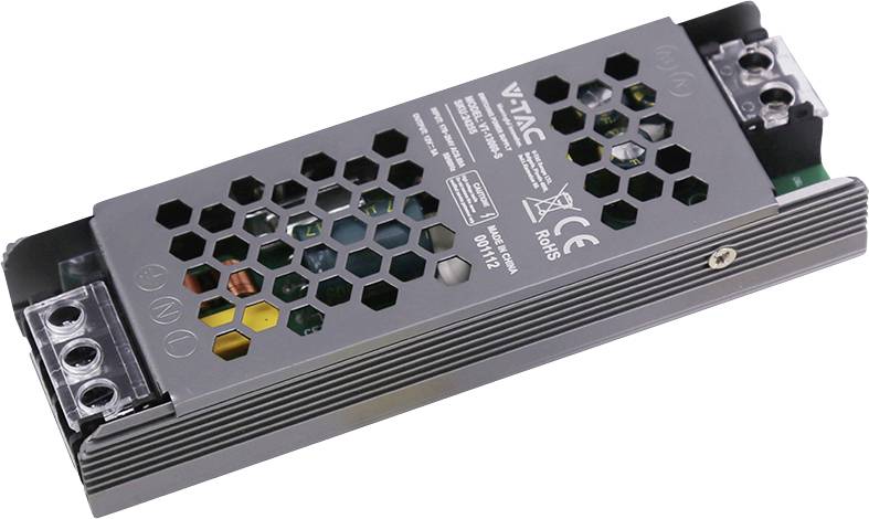 Bloc d'alimentation LED en métal rectangulaire avec des trous de ventilation hexagonaux et des bornes à vis aux deux extrémités, présenté sur un fond blanc.