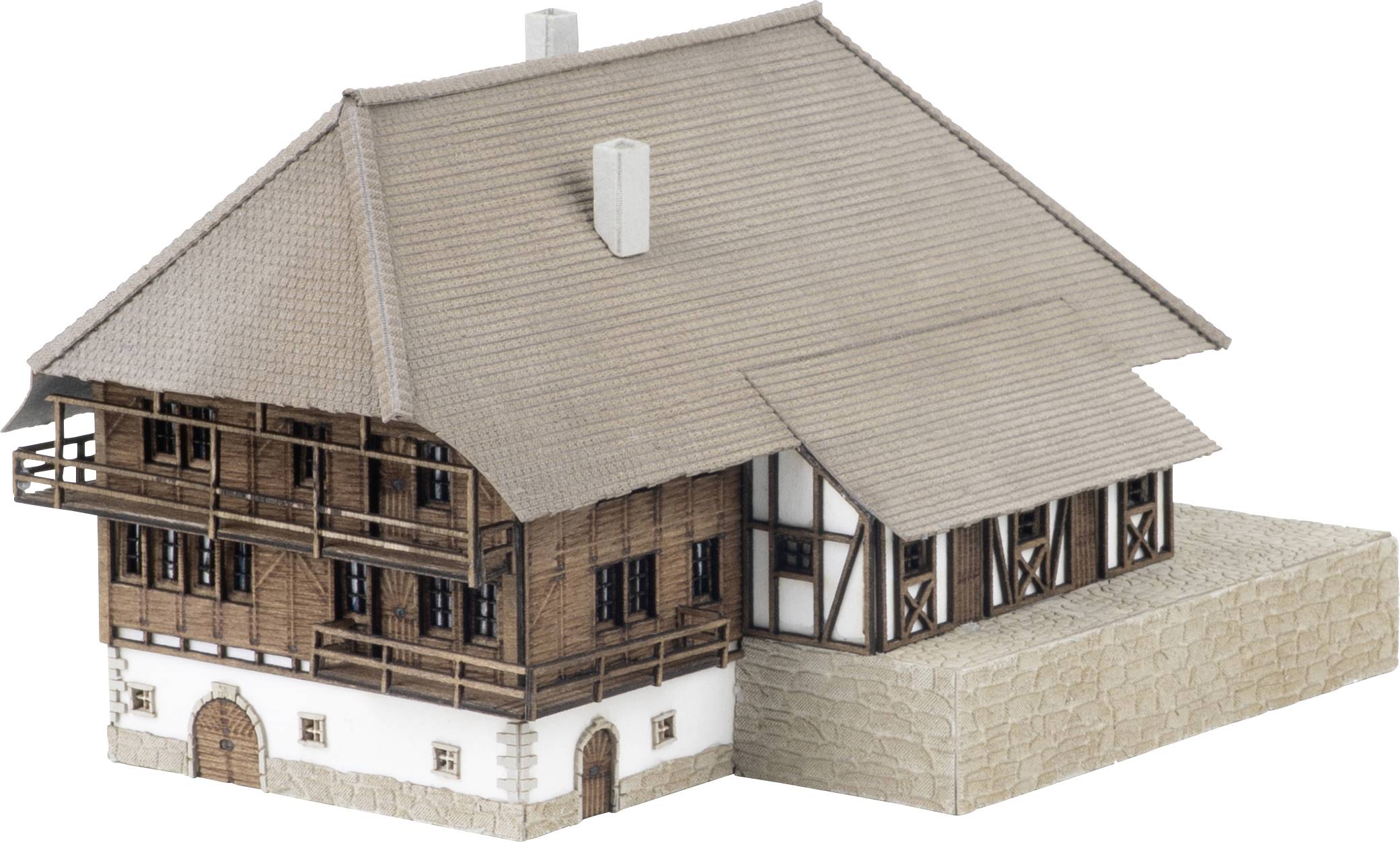 Maquette architecturale d'une maison de style chalet traditionnel avec toit en tuiles à forte pente, étages supérieurs en bois et murs inférieurs en pierre.