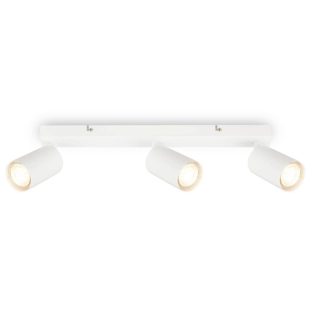 Luminaire de plafond trois lumières à rail blanc avec projecteurs cylindriques orientables sur un fond neutre.