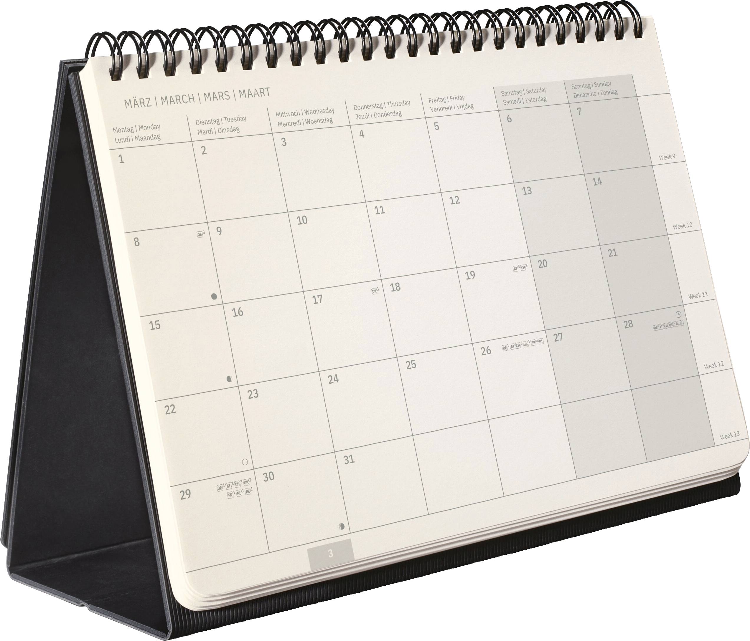 Un calendrier de bureau à reliure spirale ouvert sur le mois de mars, affichant une grille mensuelle avec les dates et les jours de la semaine.