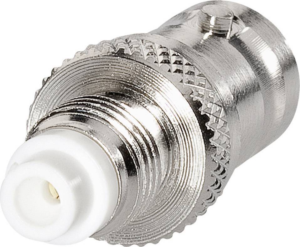 Un adaptateur d'antenne argenté avec un connecteur blanc, couramment utilisé pour relier des câbles coaxiaux pour la réception de télévision et de radio.