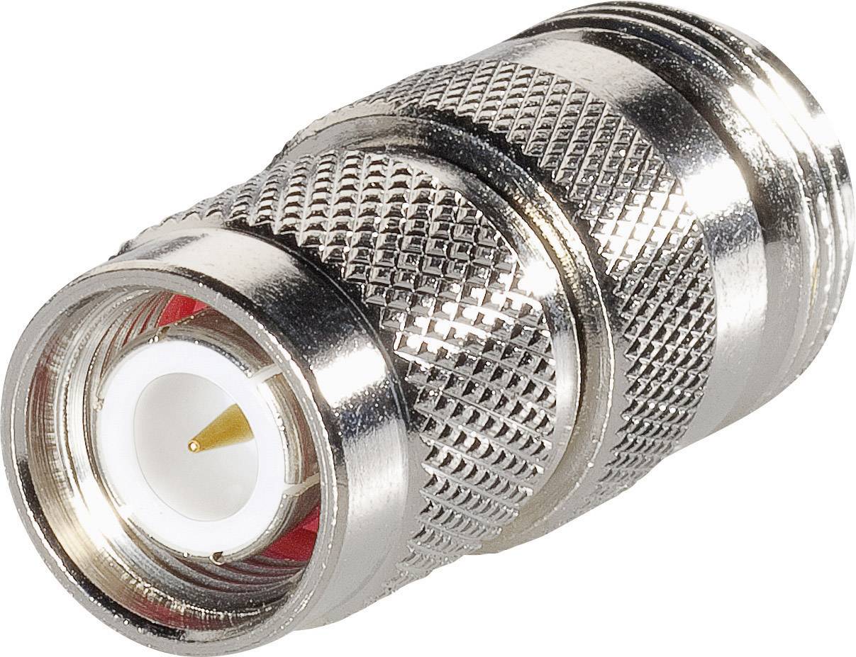 Un connecteur coaxial argenté et strié avec un intérieur rouge et une pointe centrale blanche, adapté aux connexions de câbles dans des applications techniques.