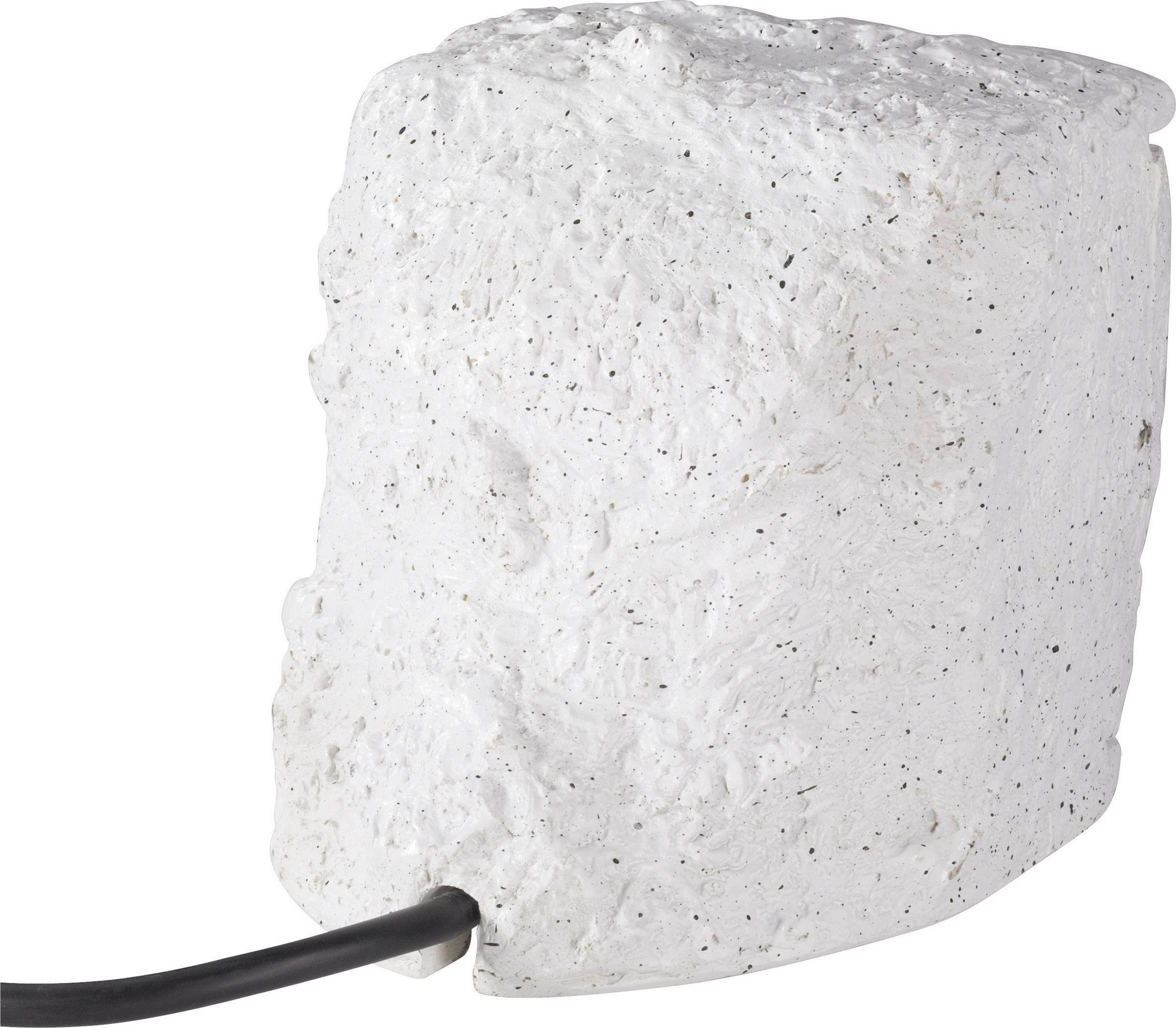 Cube en mousse blanche grossière avec un câble noir sortant d'un côté.