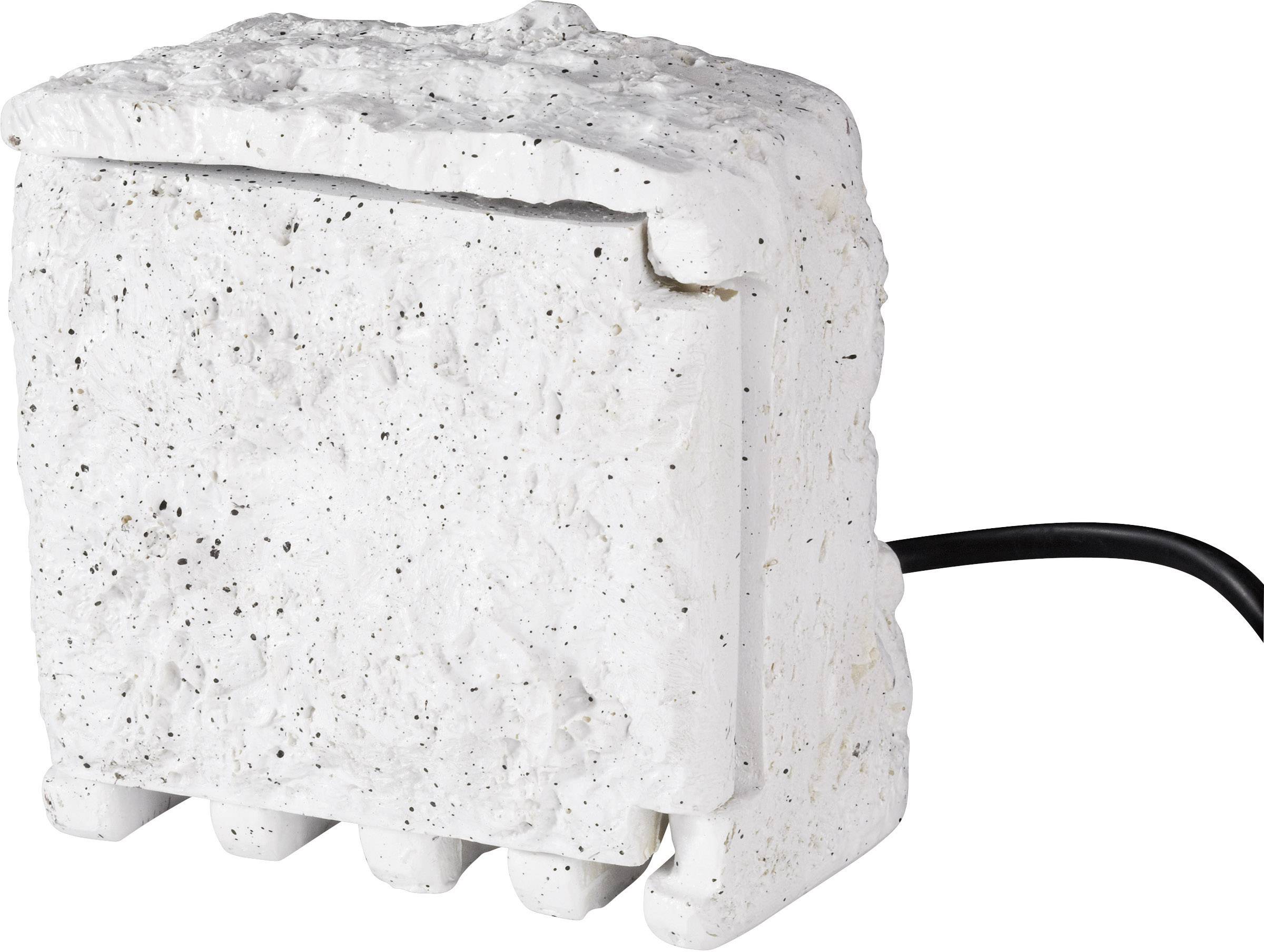 Un objet blanc rectangulaire à la surface structurée, avec un câble noir sur le côté.