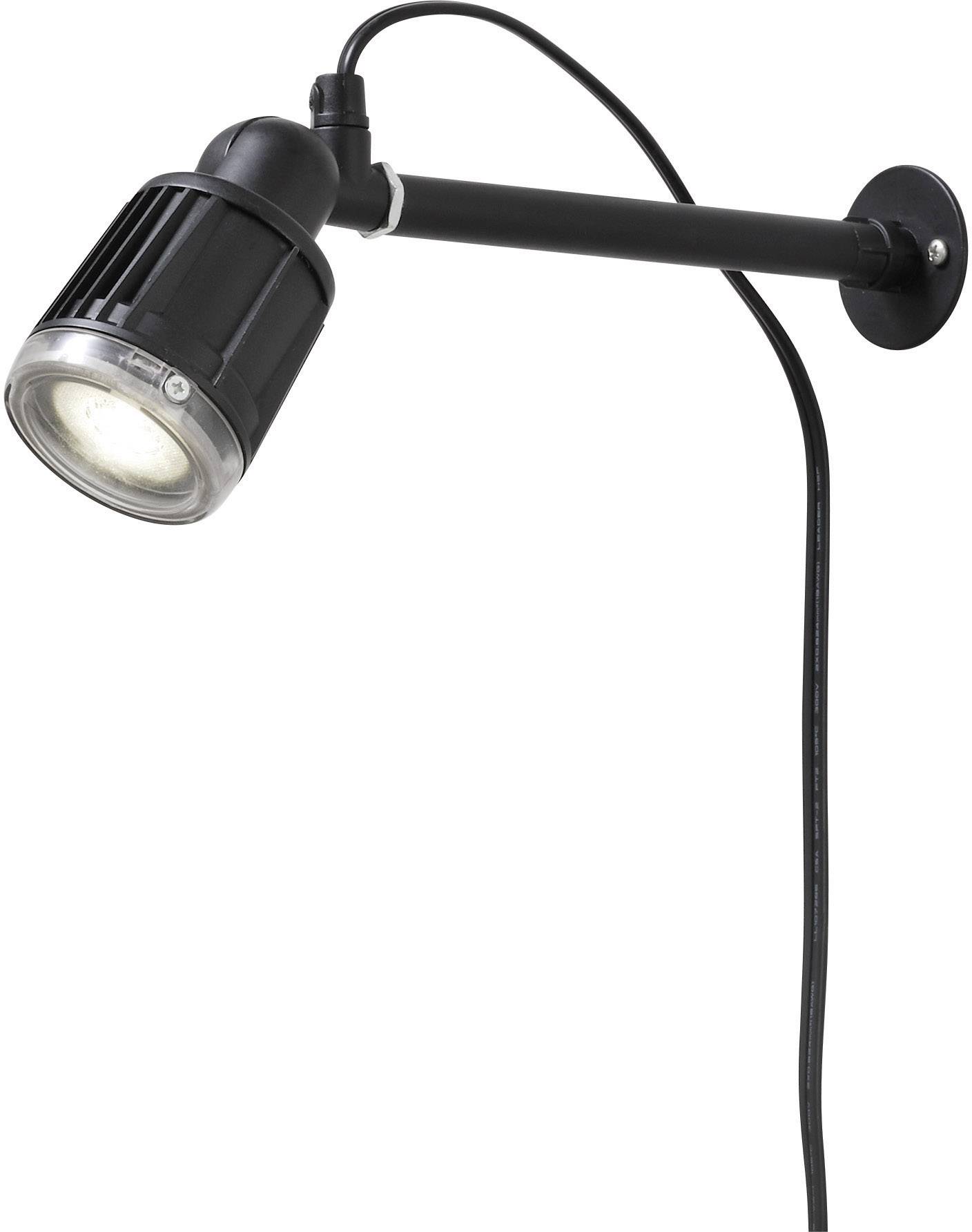 Une lampe murale noire avec un bras articulé et un câble est suspendue à un mur. Elle dispose d'un abat-jour rond.
