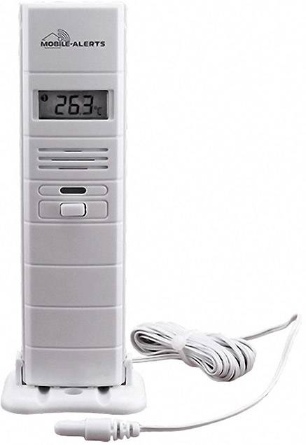 Un thermomètre numérique affiche '26,3°C'. Il a un boîtier blanc et repose sur un socle. Un câble est connecté.
