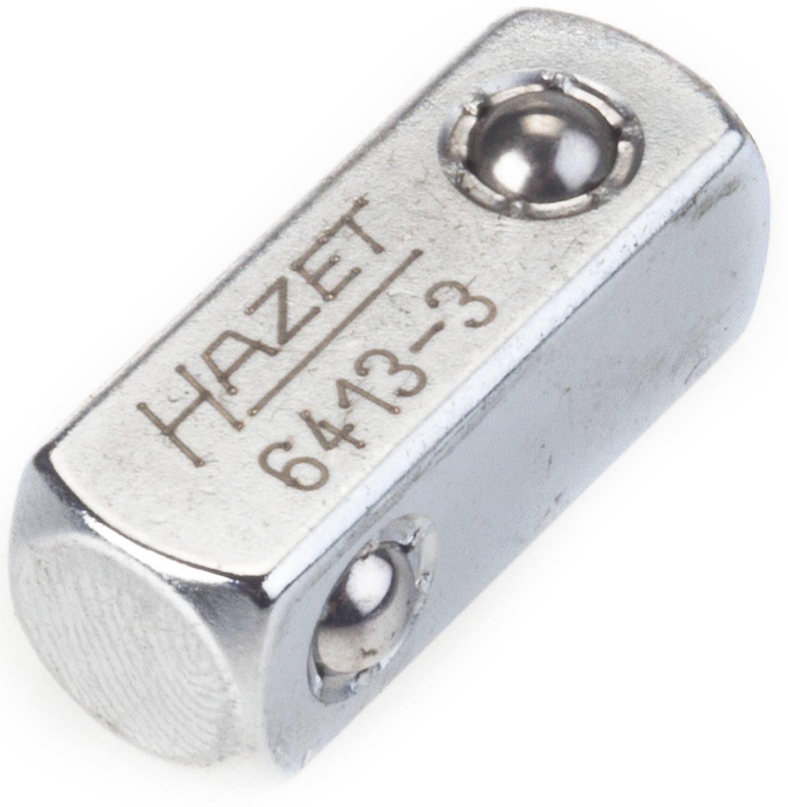 Adaptateur métallique portant l'inscription 'HAZET 6413-3', de forme rectangulaire, présentant un roulement à billes, utilisé pour des outils ou des machines.