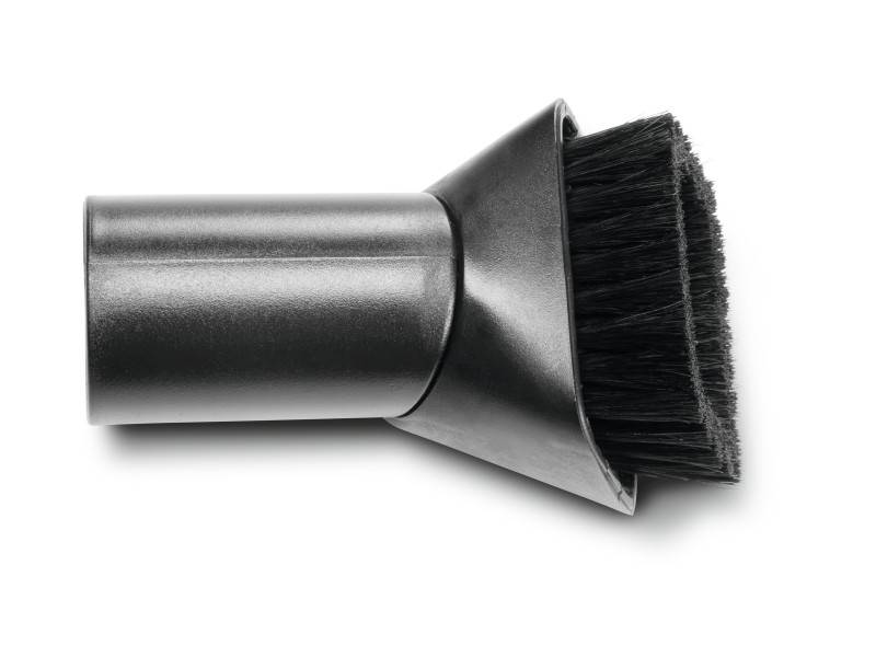 Une pièce d'accessoire d'aspirateur ronde avec des poils sombres, adaptée pour nettoyer des surfaces délicates ou des coins.