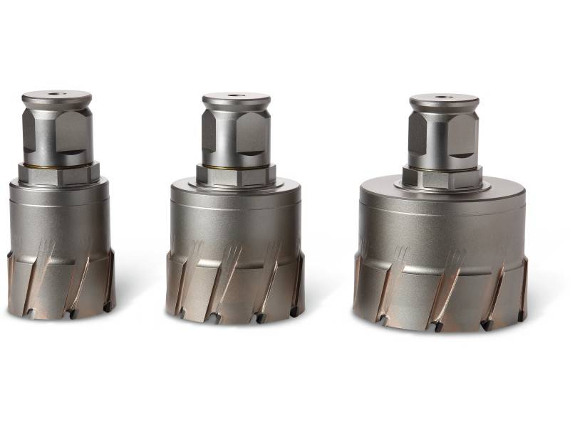 Trois têtes de forage cylindriques en métal de différentes tailles, disposées côte à côte sur un fond blanc. Elles sont de couleur argent et possèdent des bords tranchants.