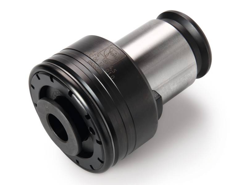 Une pièce cylindrique en métal avec un anneau en plastique noir et des découpes, probablement un composant mécanique ou industriel.