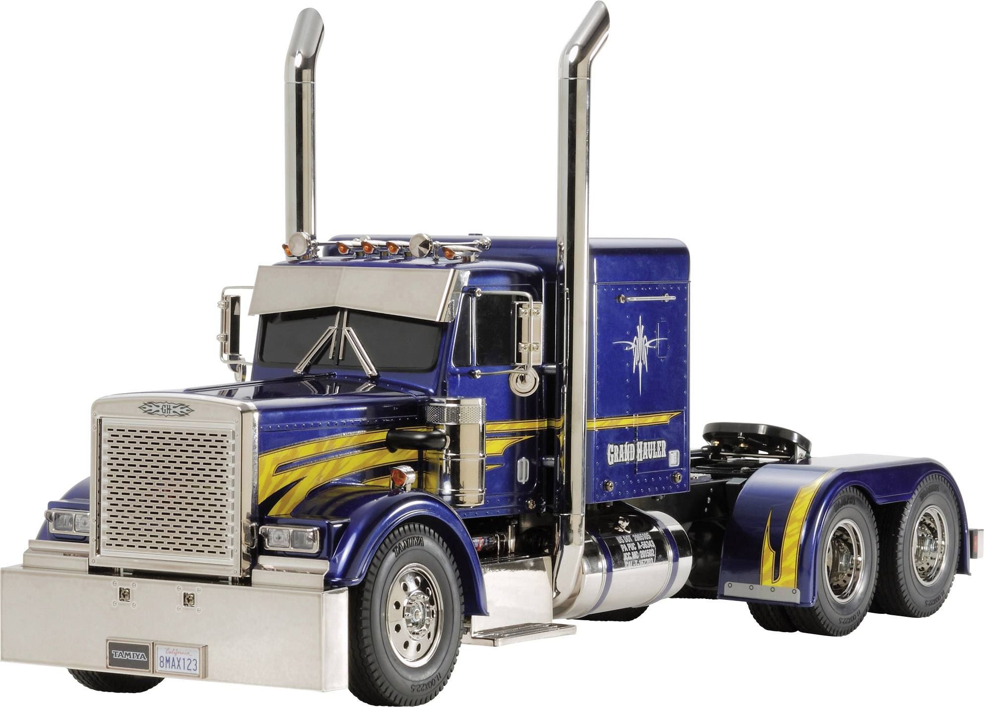 Un camion bleu avec des bandes jaunes est stationné sur une route. Le camion possède deux tuyaux d'échappement chromés et hauts.
