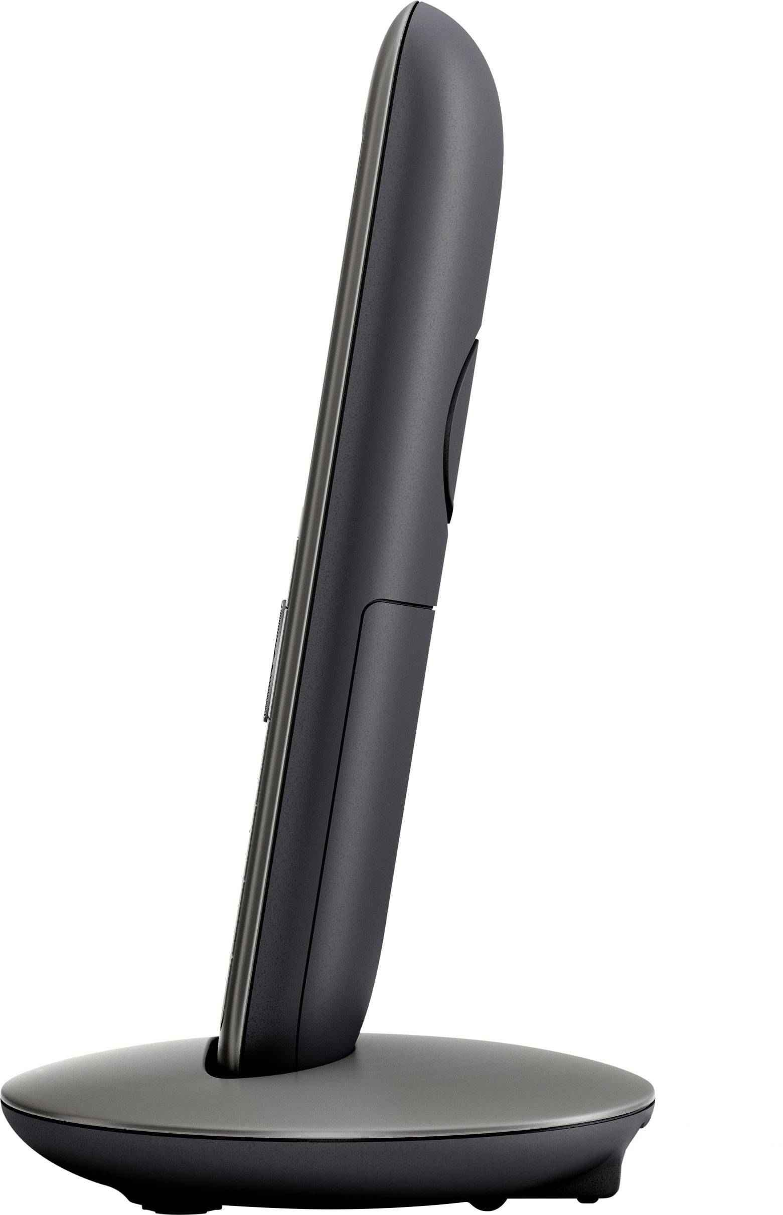 Téléphone sans fil posé sur sa station de charge, vue de côté ; design élégant et moderne.