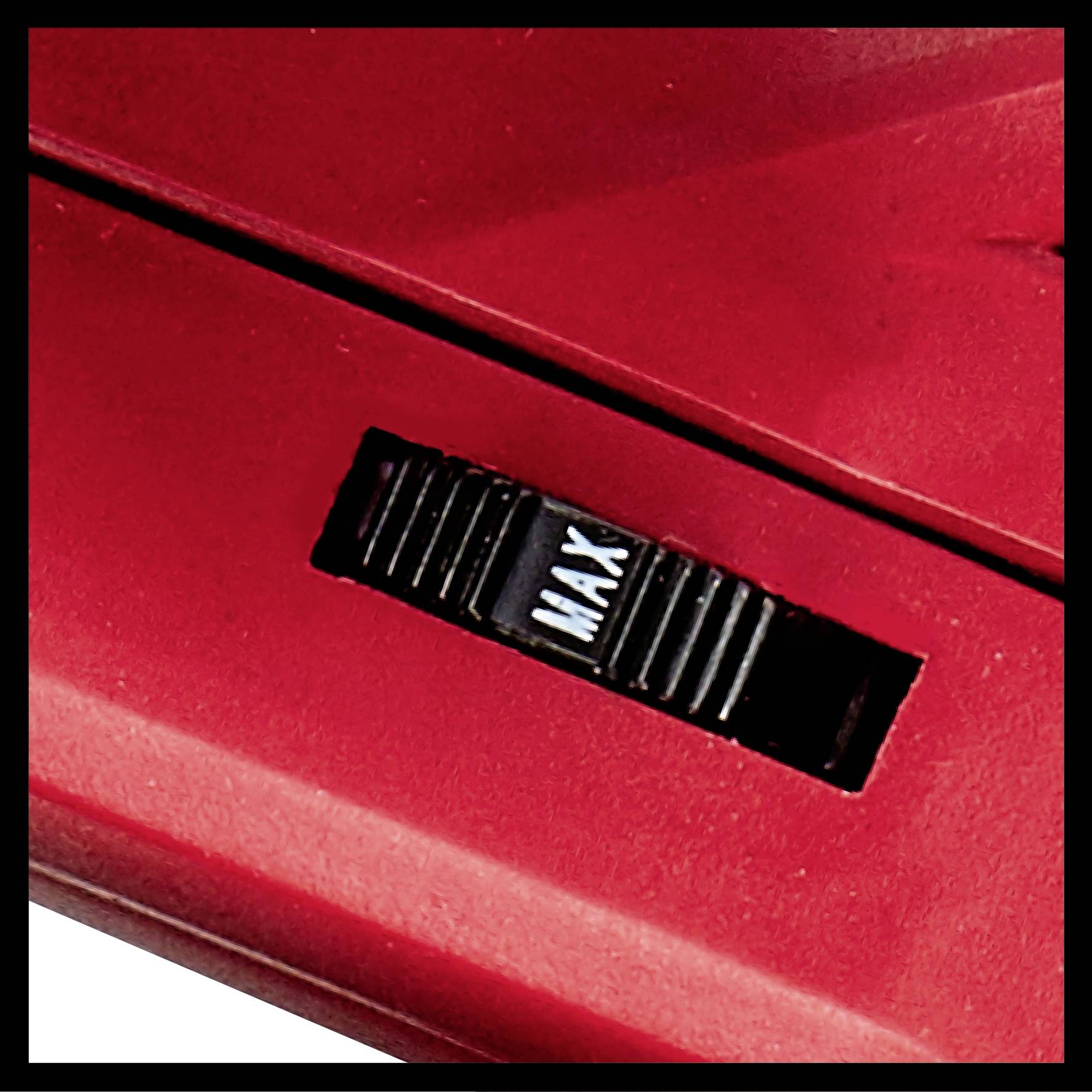 Gros plan d'un bouton rouge sur un appareil, réglé sur 'MAX'. Pourrait faire partie d'un dispositif de contrôle de puissance pour un appareil électroménager.