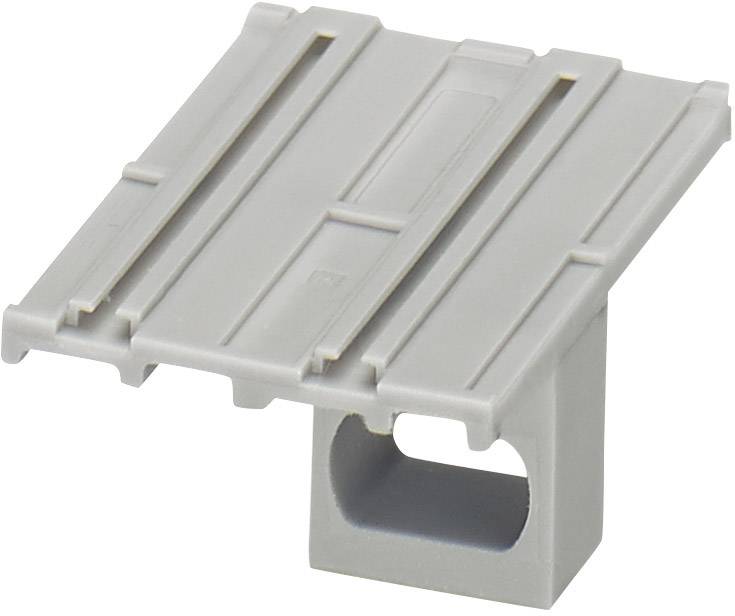 Pièce en plastique grise avec une surface rectangulaire striée et une cavité rectangulaire en bas. Usage inconnu.