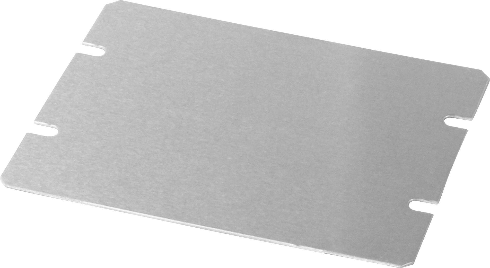 Plaque métallique (argentée, rectangulaire) avec quatre encoches sur les côtés. Posée en biais sur une surface claire.