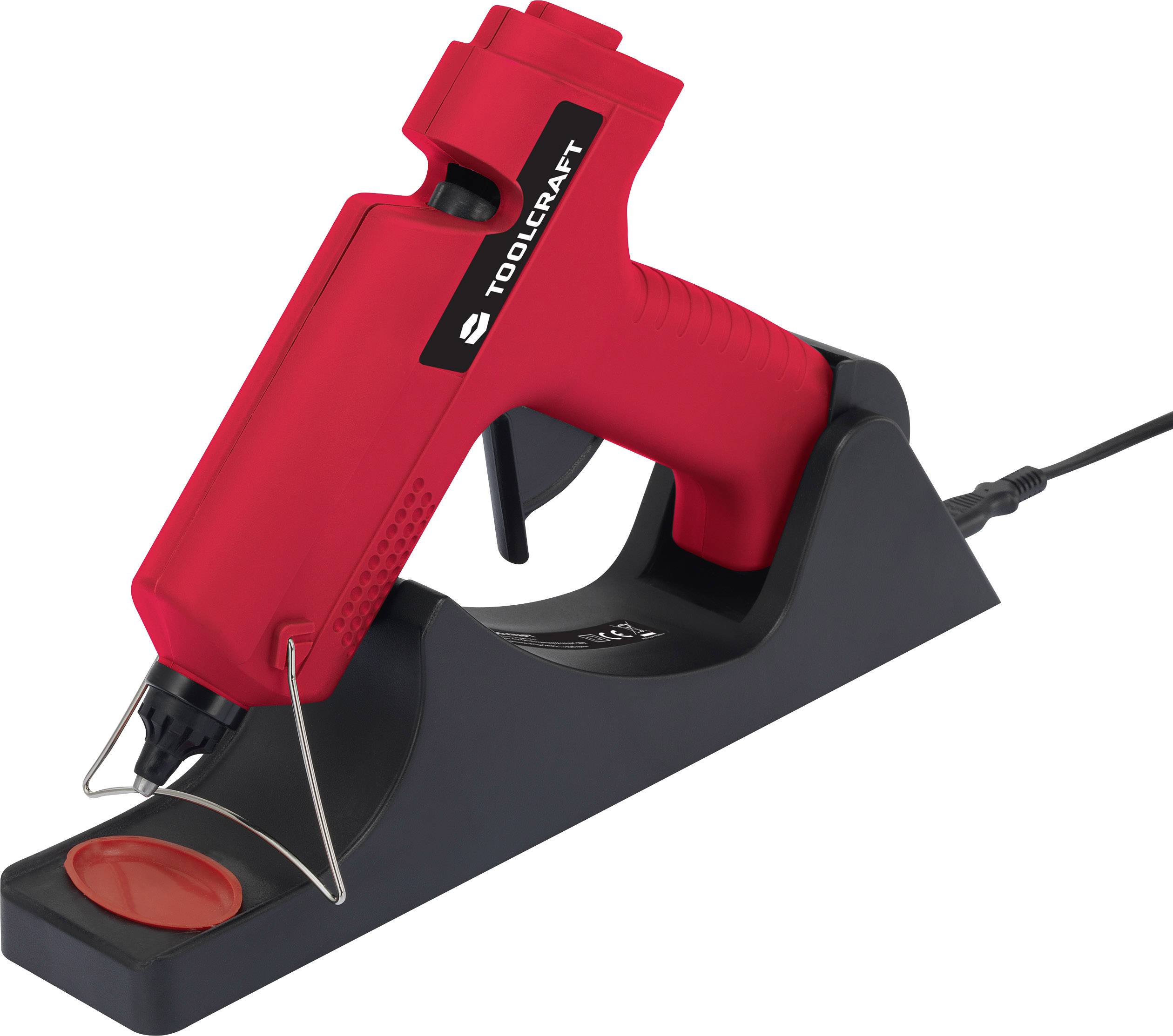 Un pistolet à colle chaude rouge est posé en biais sur une base noire. Un câble est connecté à la base.