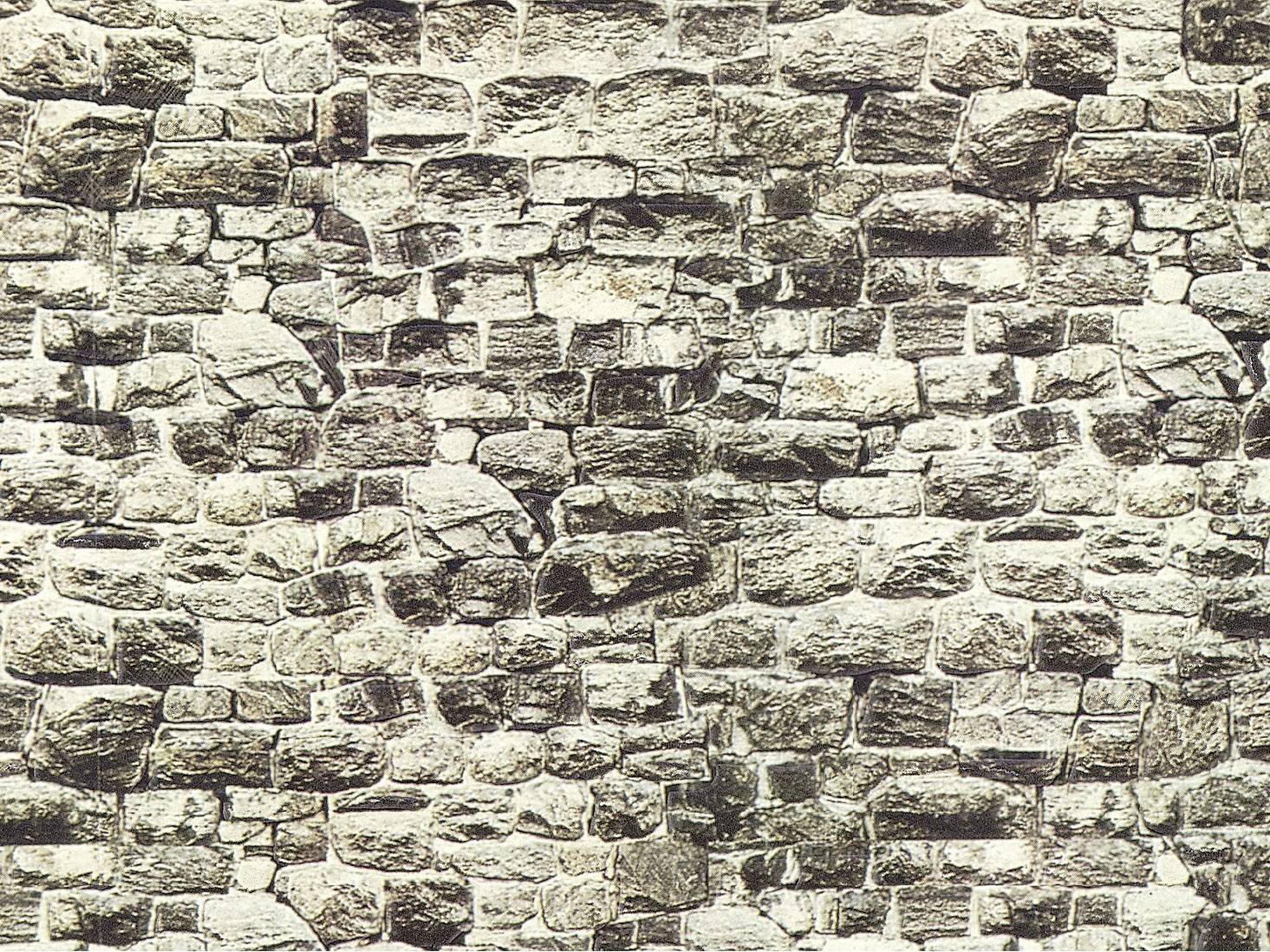 Mur composé de pierres grises de taille moyenne, de forme irrégulière, avec des joints apparents selon un motif typique de brique.