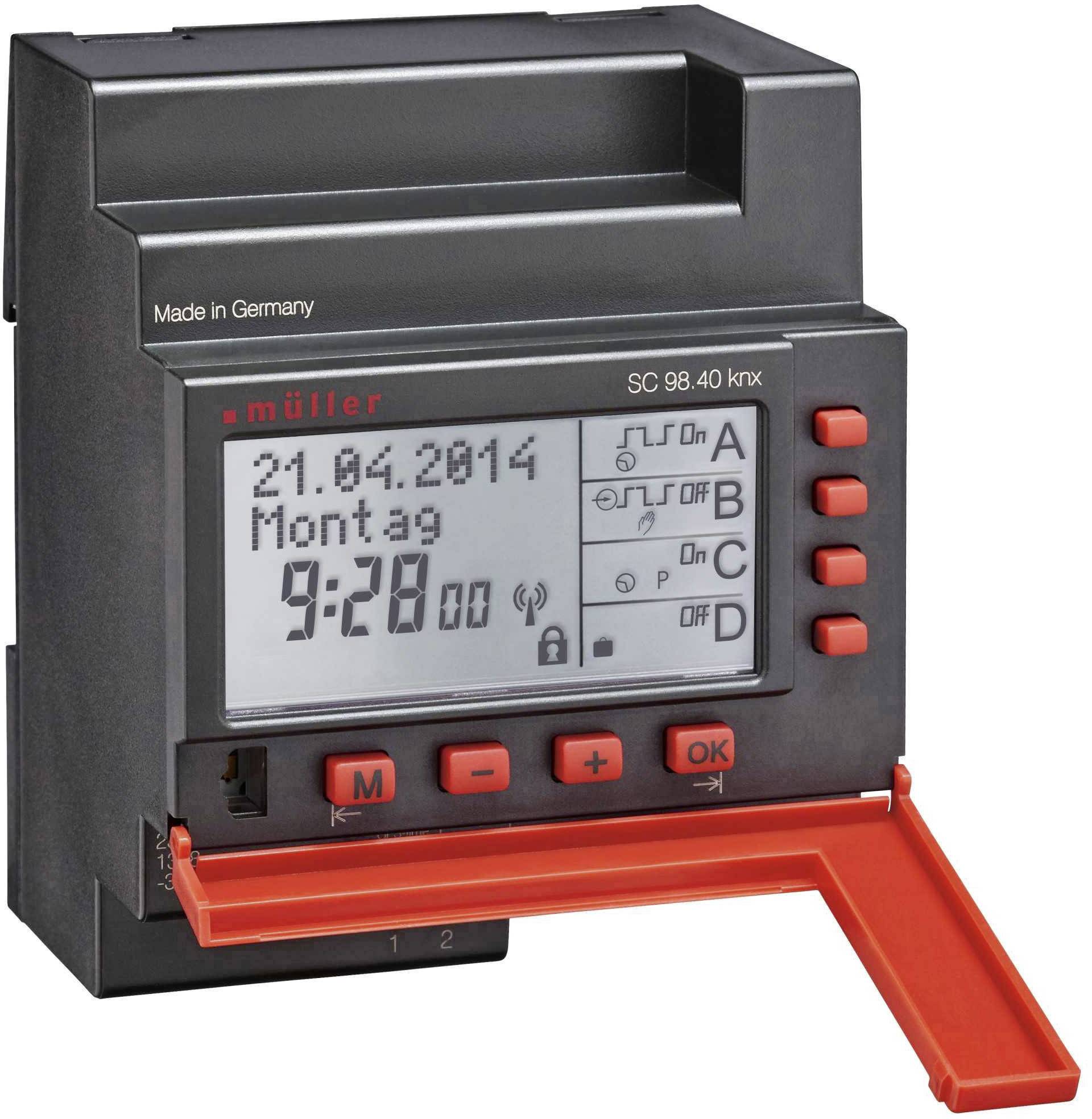 Une horloge numérique avec affichage montre la date '21.04.2014', le jour de la semaine 'Lundi' et l'heure '9:28'. Plusieurs touches sont visibles.