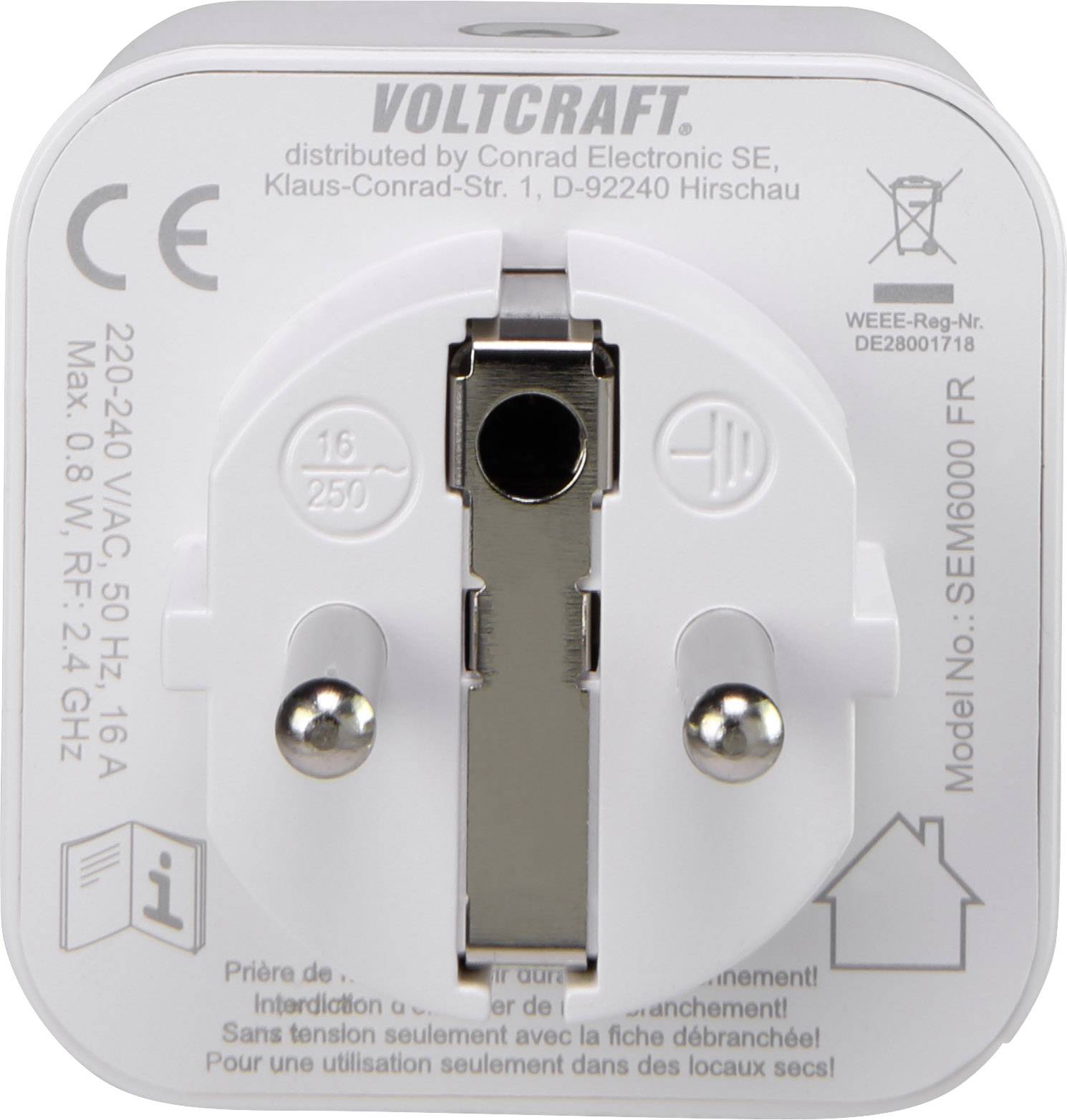 Un adaptateur blanc de Voltcraft avec des spécifications techniques et un numéro de modèle sur la face avant. Contacts enfichables au centre.
