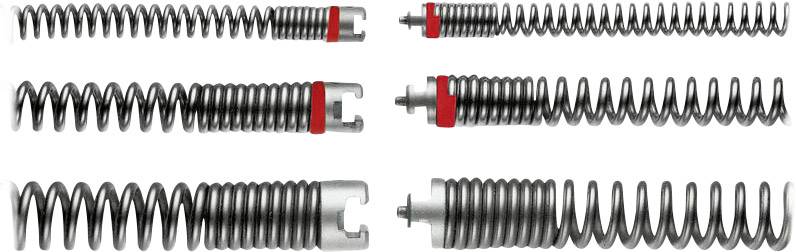 Six ressorts métalliques de différentes tailles et formes, certains avec des marquages rouges. Les ressorts sont disposés côte à côte sur un fond blanc.