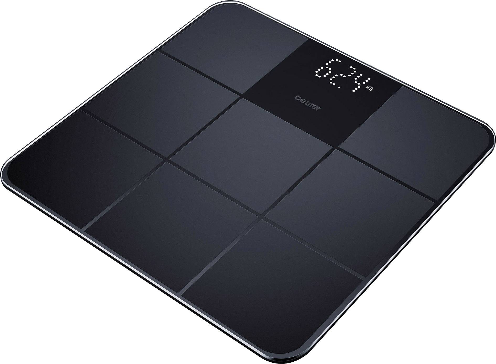 Balance numérique personnelle avec affichage LED, indiquant '62,4 kg'. Design noir avec surfaces carrées.