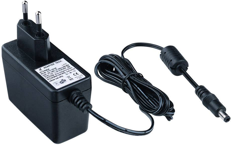Un adaptateur secteur noir avec une fiche européenne et un câble d'alimentation. L'adaptateur porte des spécifications techniques et divers logos de certification imprimés.