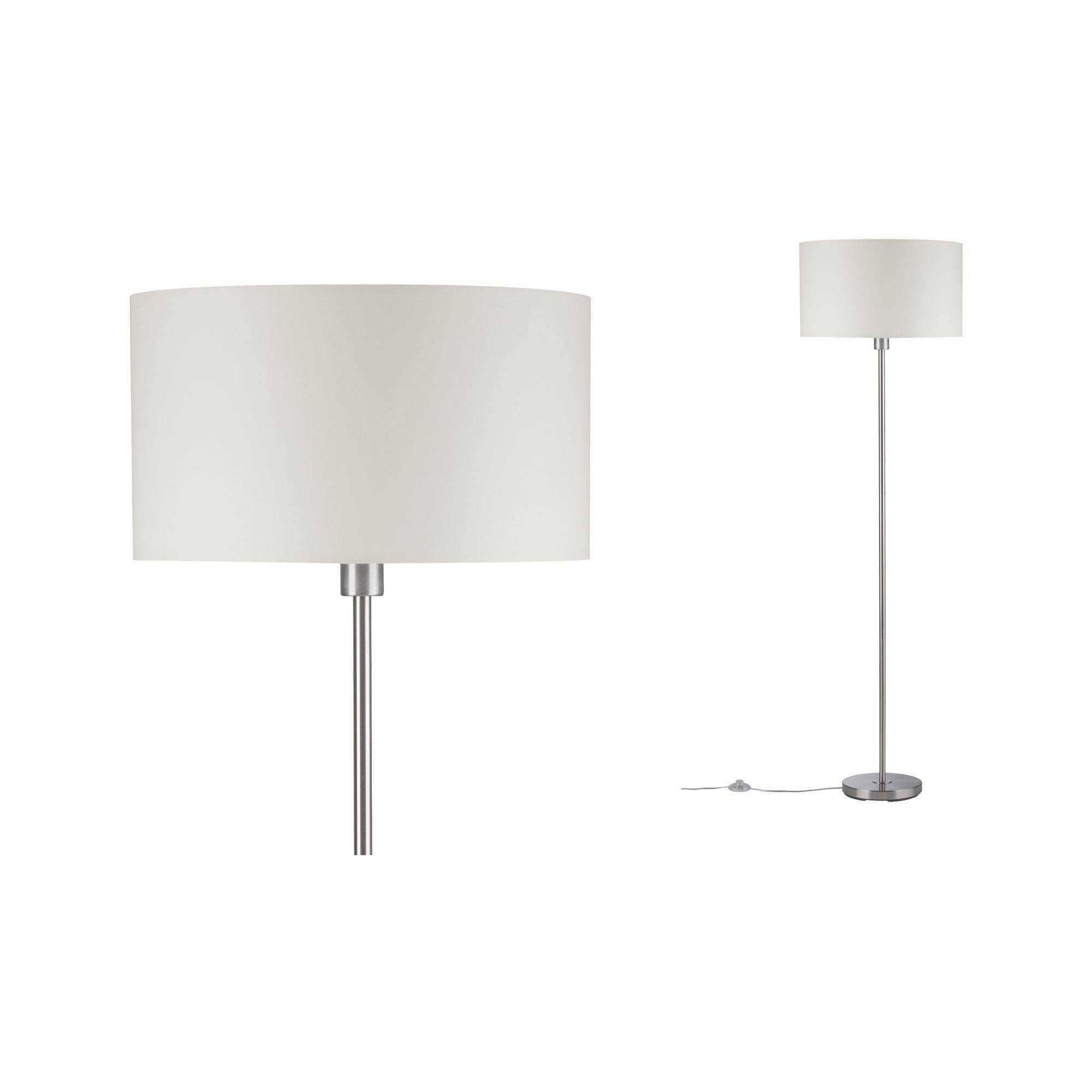 Lampadaire avec abat-jour rond et lumineux, et pied élancé argenté.