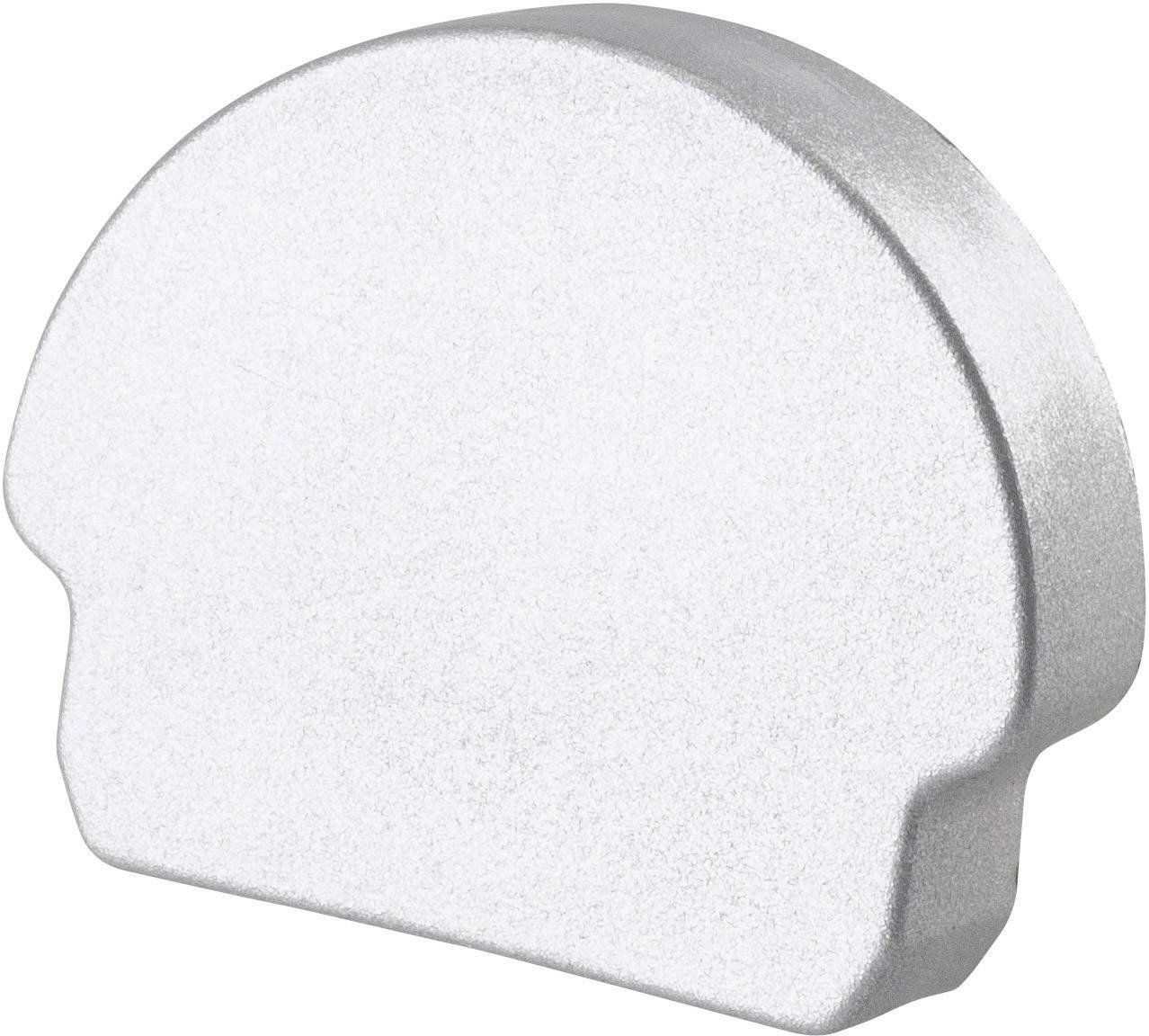 Objet métallique argenté en forme de demi-cercle sur un fond blanc.