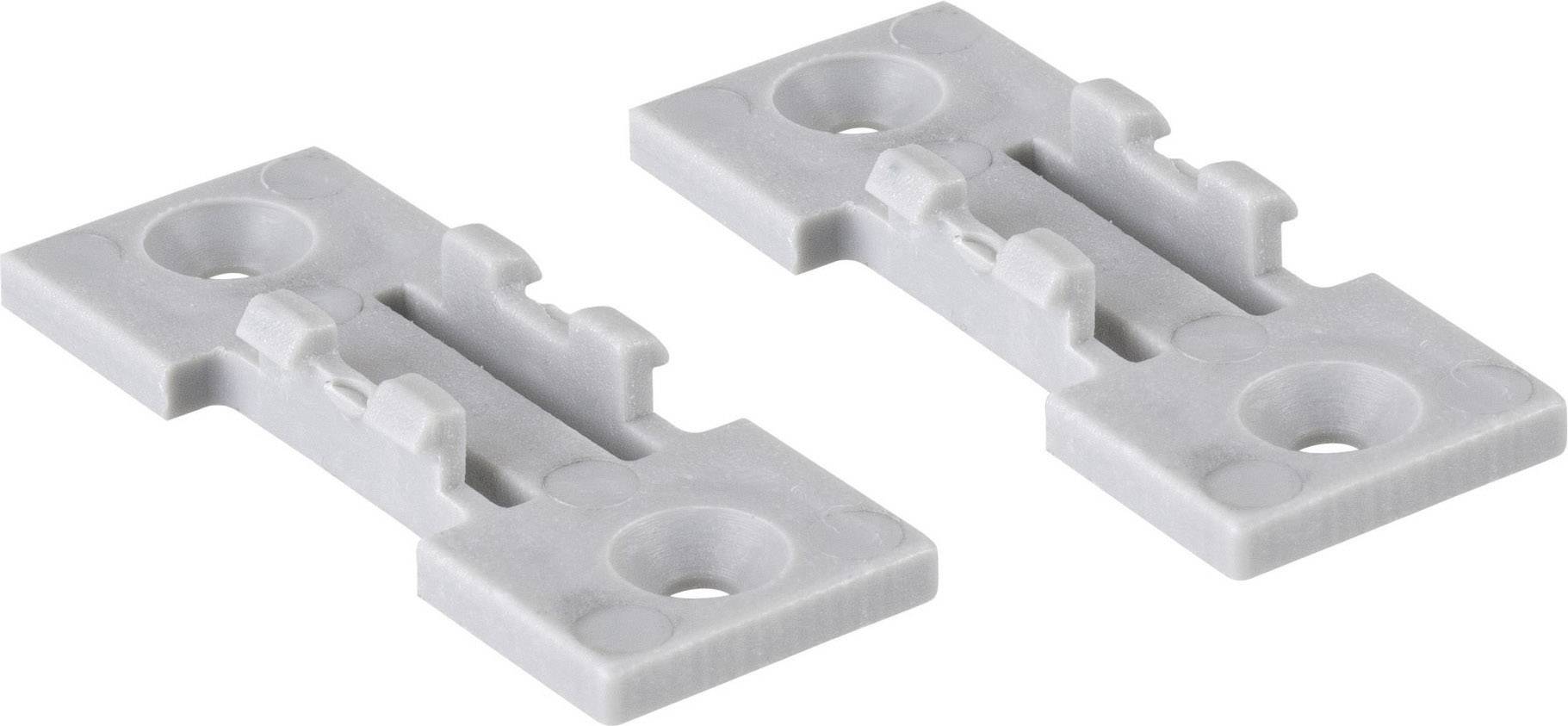 Deux plaques de montage en plastique gris avec des trous de fixation, adaptées pour la fixation d'objets sur des surfaces planes.