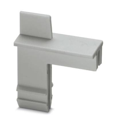 Un objet en plastique gris de forme L, servant de capuchon de protection pour un tableau électrique industriel ou un appareil similaire.