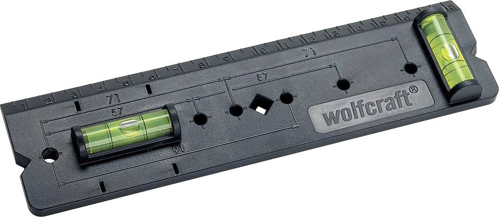 Niveau à bulle avec deux fioles et règle, marque 'wolfcraft', pour un alignement et une mesure précis sur une surface plane.
