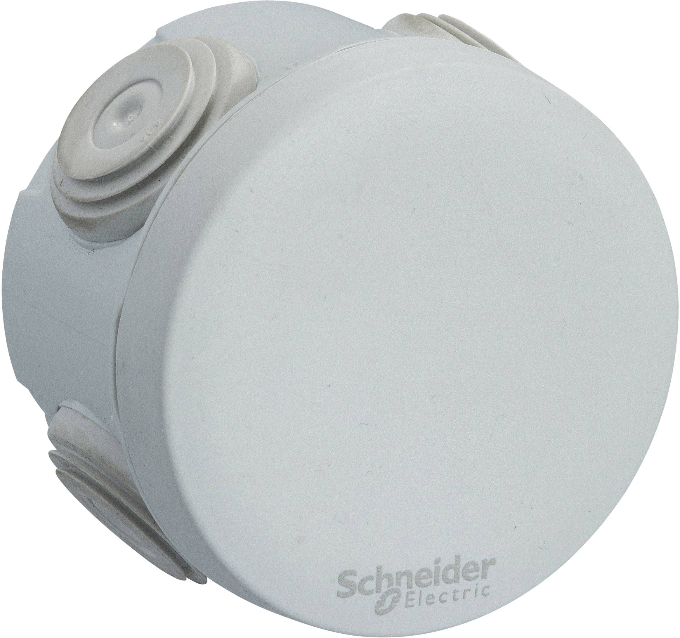 Un boîtier de raccordement rond blanc de la marque Schneider Electric avec plusieurs passages de câbles latéraux.