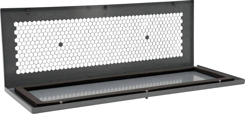 Plaque métallique avec un motif de trous hexagonaux, ouverte en haut. Posée sur une surface plane, probablement partie d'un système de ventilation.