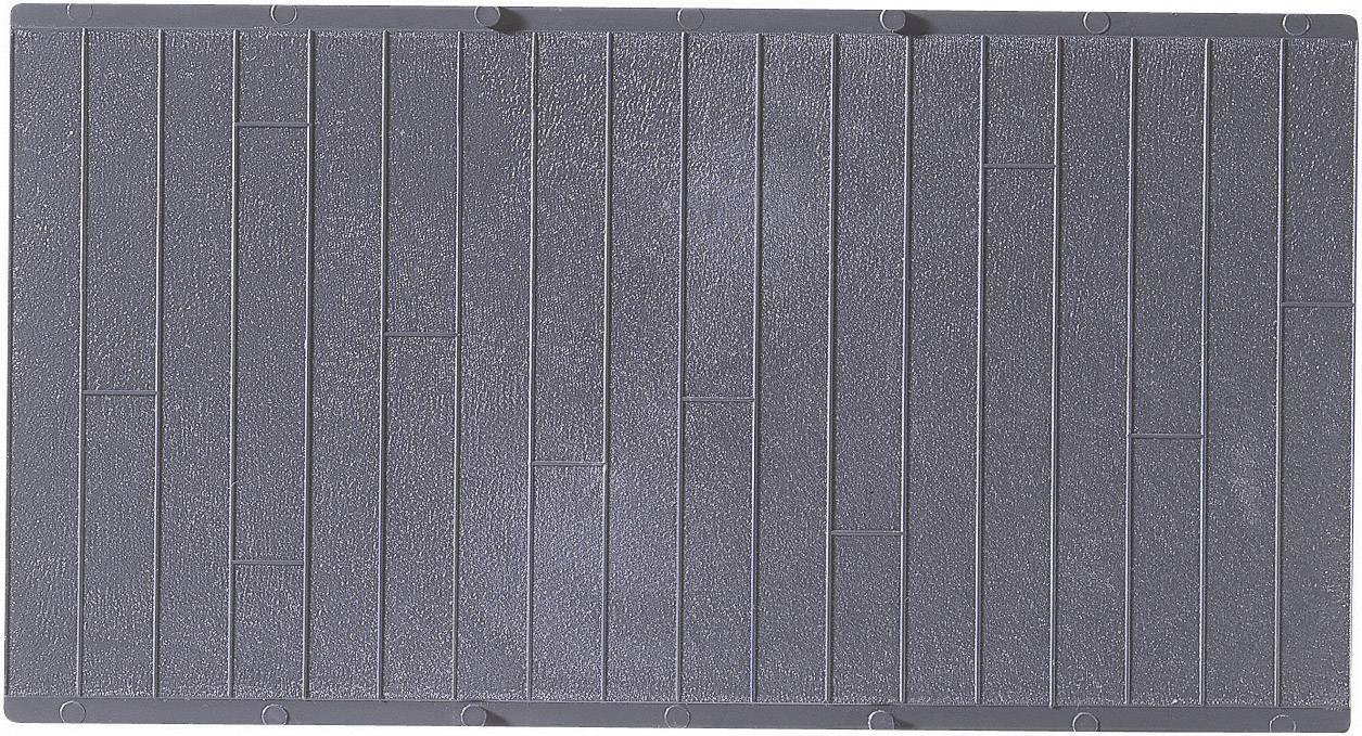 Surface grise avec des motifs rectangulaires structurés. Les dalles sont disposées de manière uniforme et forment des lignes parallèles.