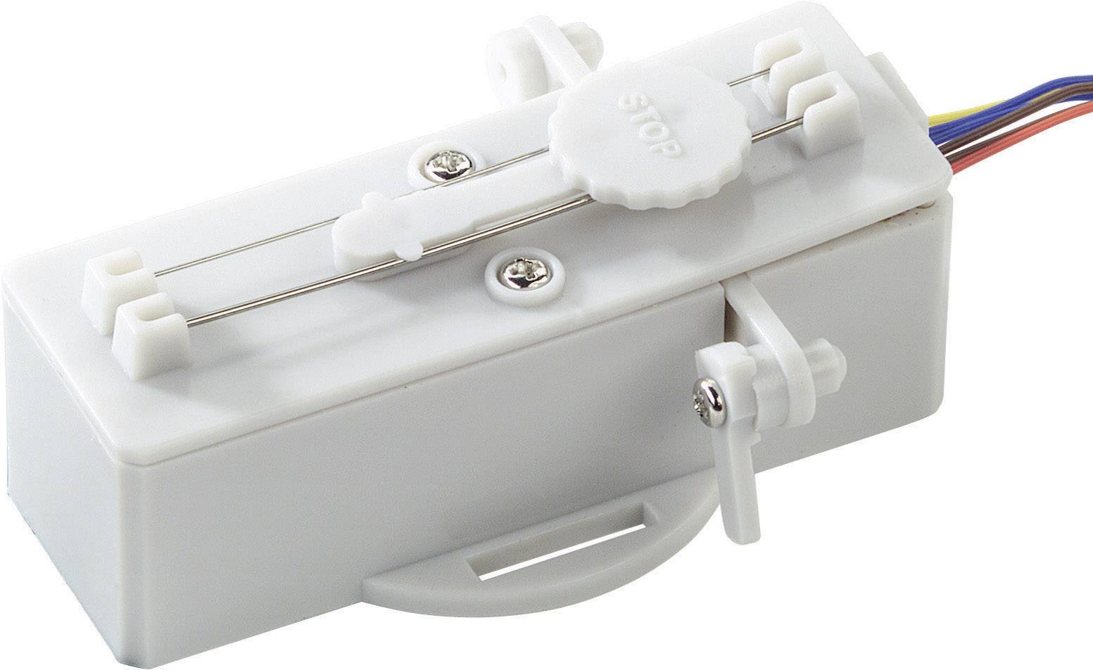 Un moteur blanc rectangulaire avec un curseur coulissant et plusieurs câbles électroniques.