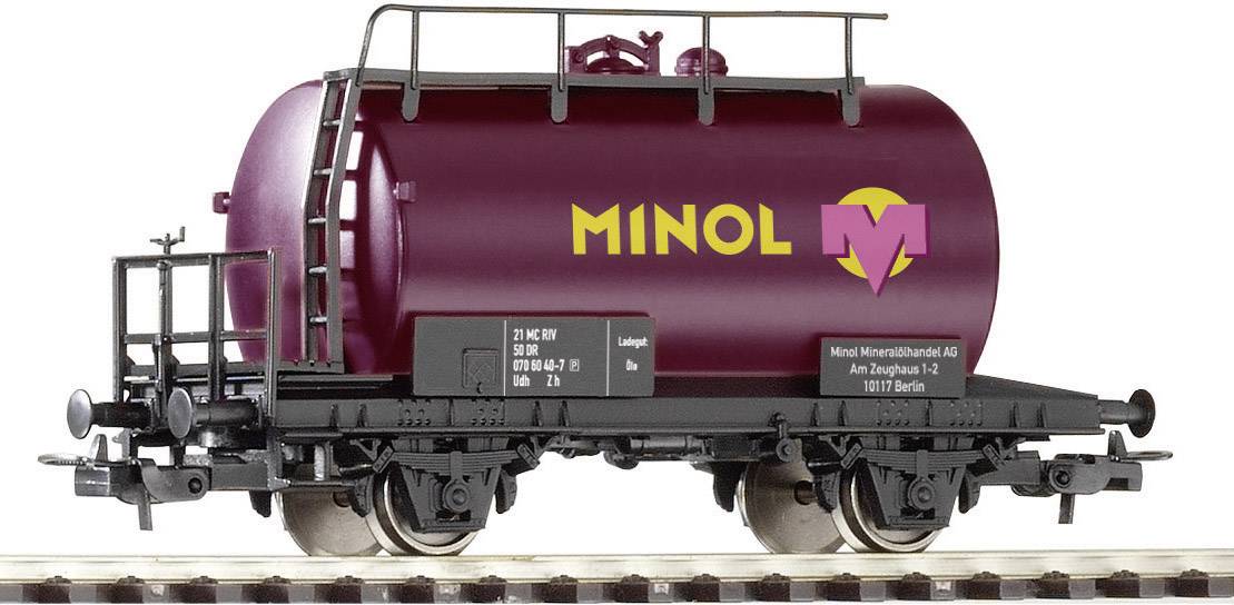 Un wagon-citerne de train miniature avec l'inscription 'Minol' en rouge et violet. Le wagon est posé sur des rails et présente des détails ferroviaires caractéristiques.