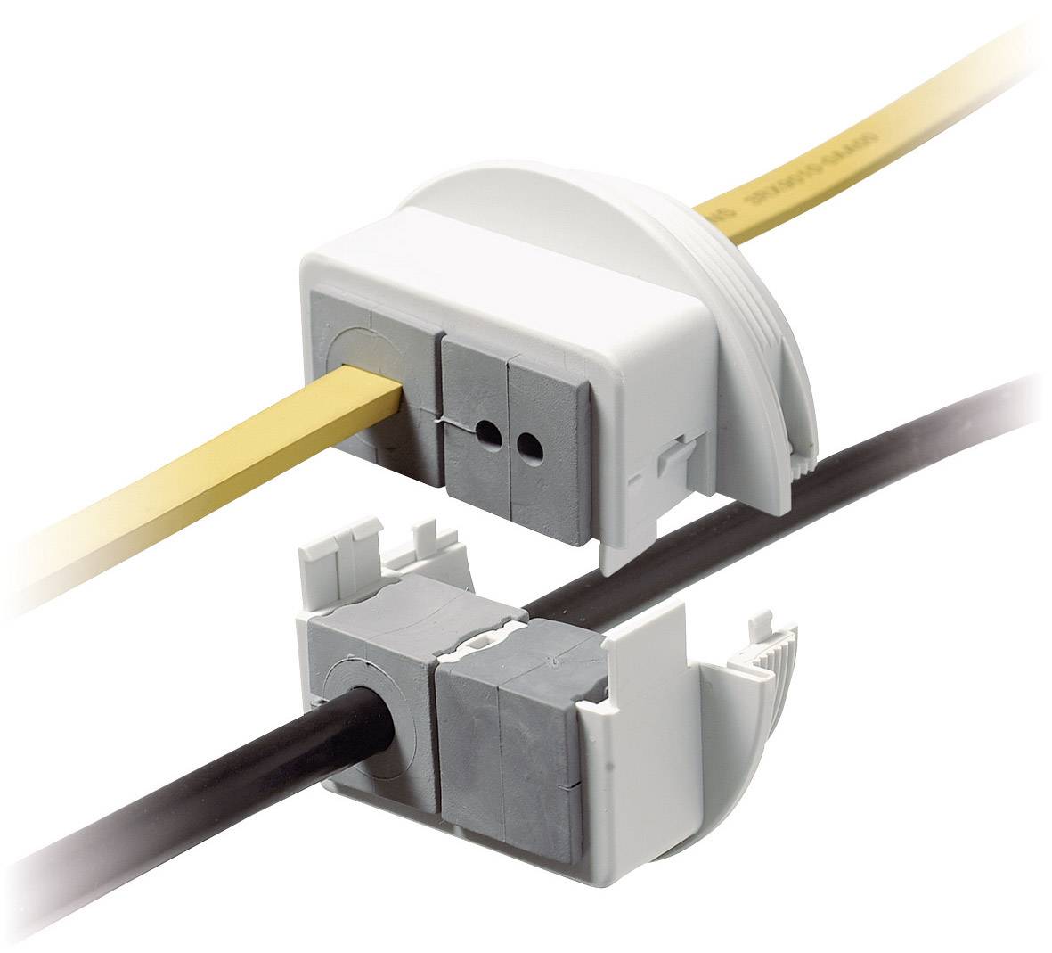 Un filtre antiparasite à noyau de ferrite rabattable entoure deux câbles afin de réduire les interférences électromagnétiques.