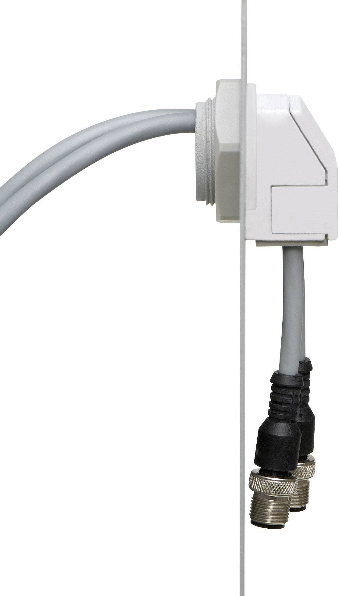Passage de câble avec boîtier blanc, fixé au mur. Deux câbles coaxiaux sont connectés.