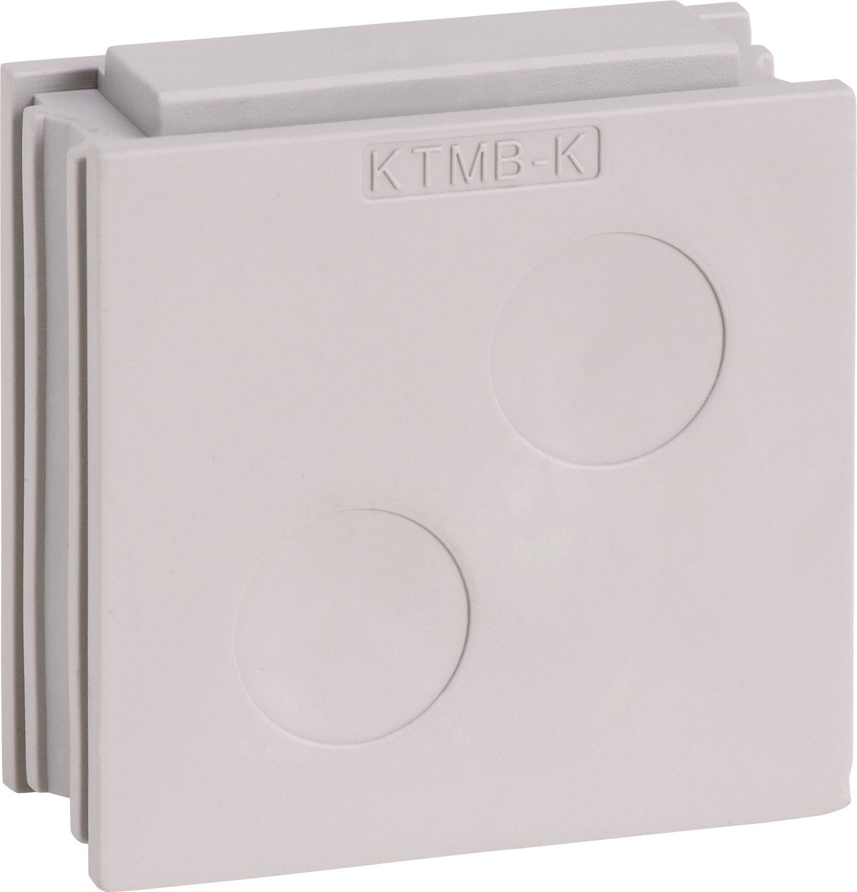 Un couvercle en plastique gris, carré, portant l'empreinte 'KTMB-K'. Il comporte deux cavités rondes et un bord étagé.