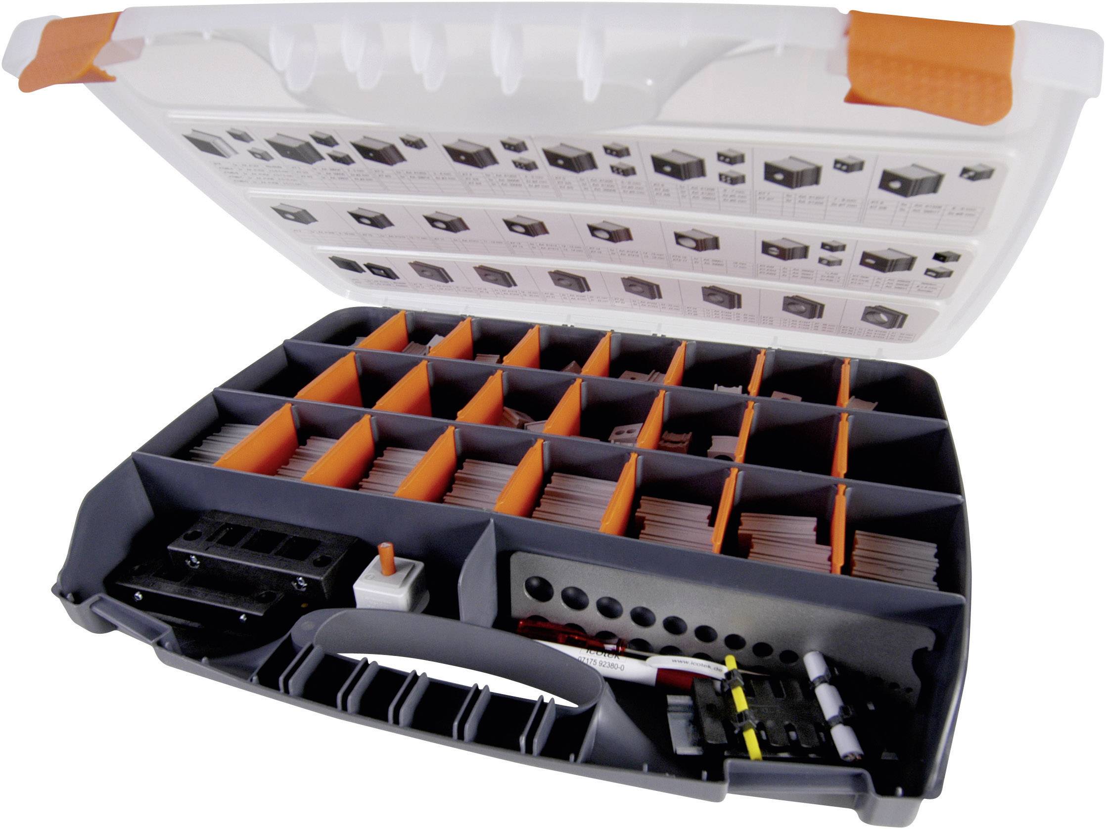 Valise ouverte à plusieurs compartiments, remplie de divers petits composants électroniques et comportant un diagramme à l'intérieur du couvercle.
