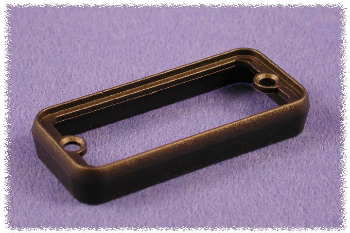 Cadre rectangulaire en plastique noir avec deux trous de fixation, posé sur un fond lilas.