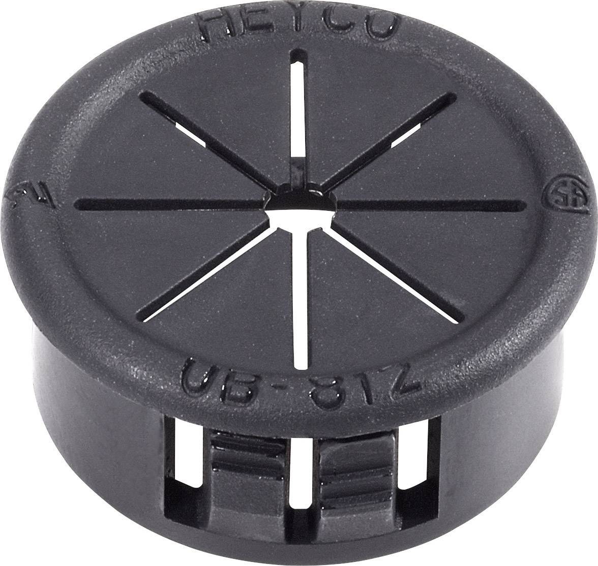 Bouchon en plastique noir avec fentes et inscription 'HEYCO UB-612'. Utilisé pour le passage de câbles dans les boîtiers.