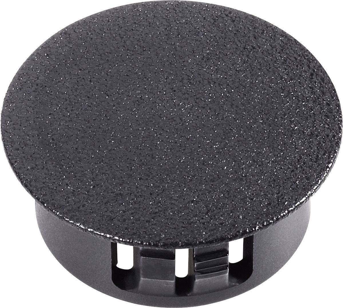 Passe-câbles rond noir en plastique, adapté pour un acheminement ordonné des câbles sur les bureaux ou les postes de travail.