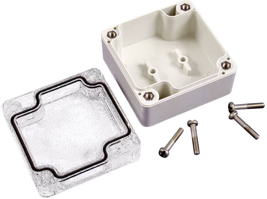 Boîtier avec son couvercle transparent retiré et quatre vis à côté. Adapté pour les installations électriques.