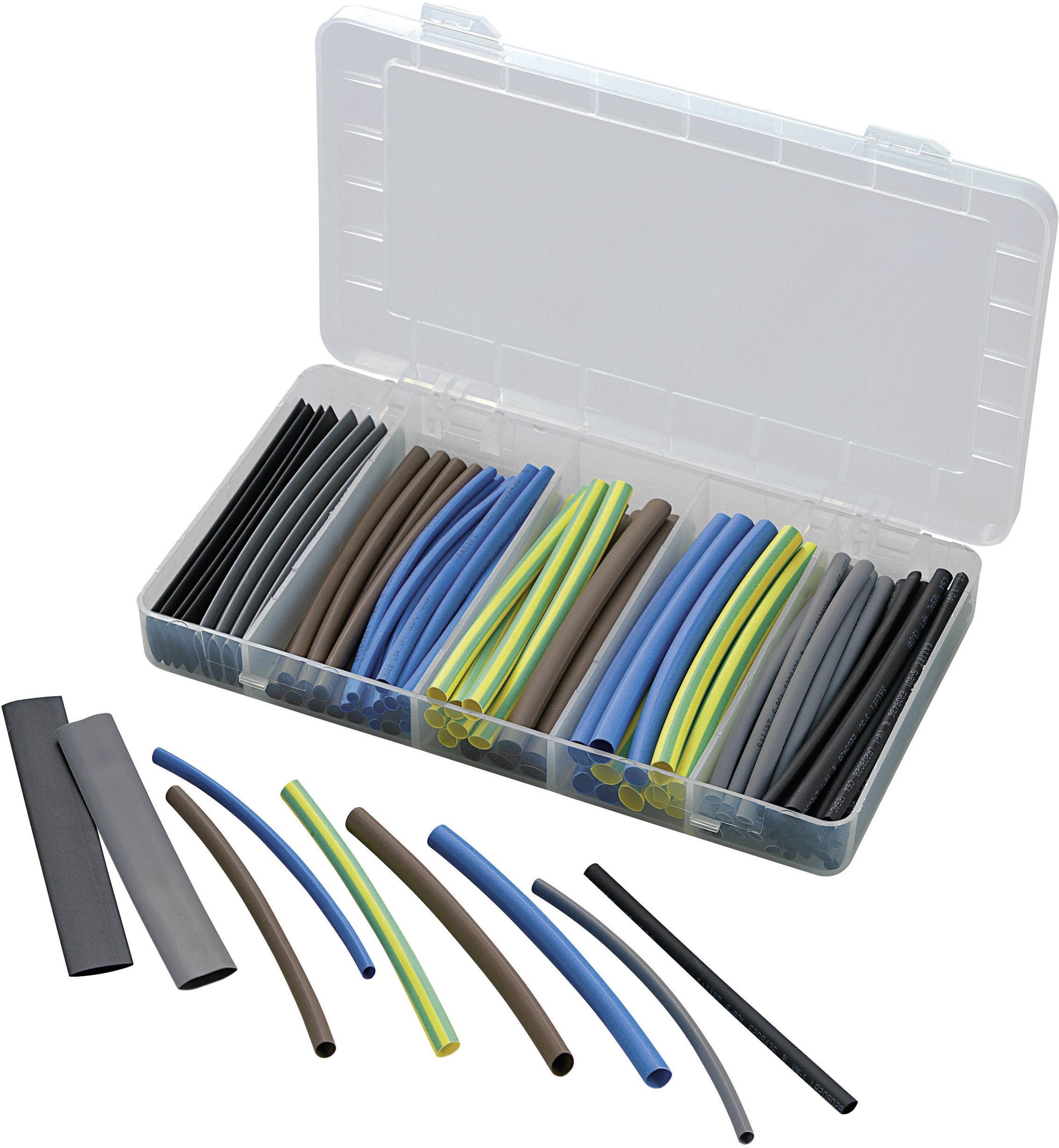 Une boîte en plastique ouverte contient des gaines thermorétractables colorées de différentes tailles. Quelques gaines thermorétractables sont disposées devant la boîte.