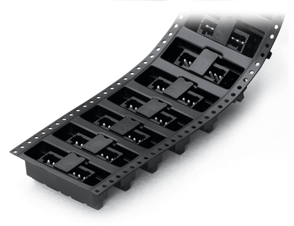 Bandes de plastique noir avec des composants électroniques intégrés dans des boîtiers rectangulaires, disposés régulièrement côte à côte.