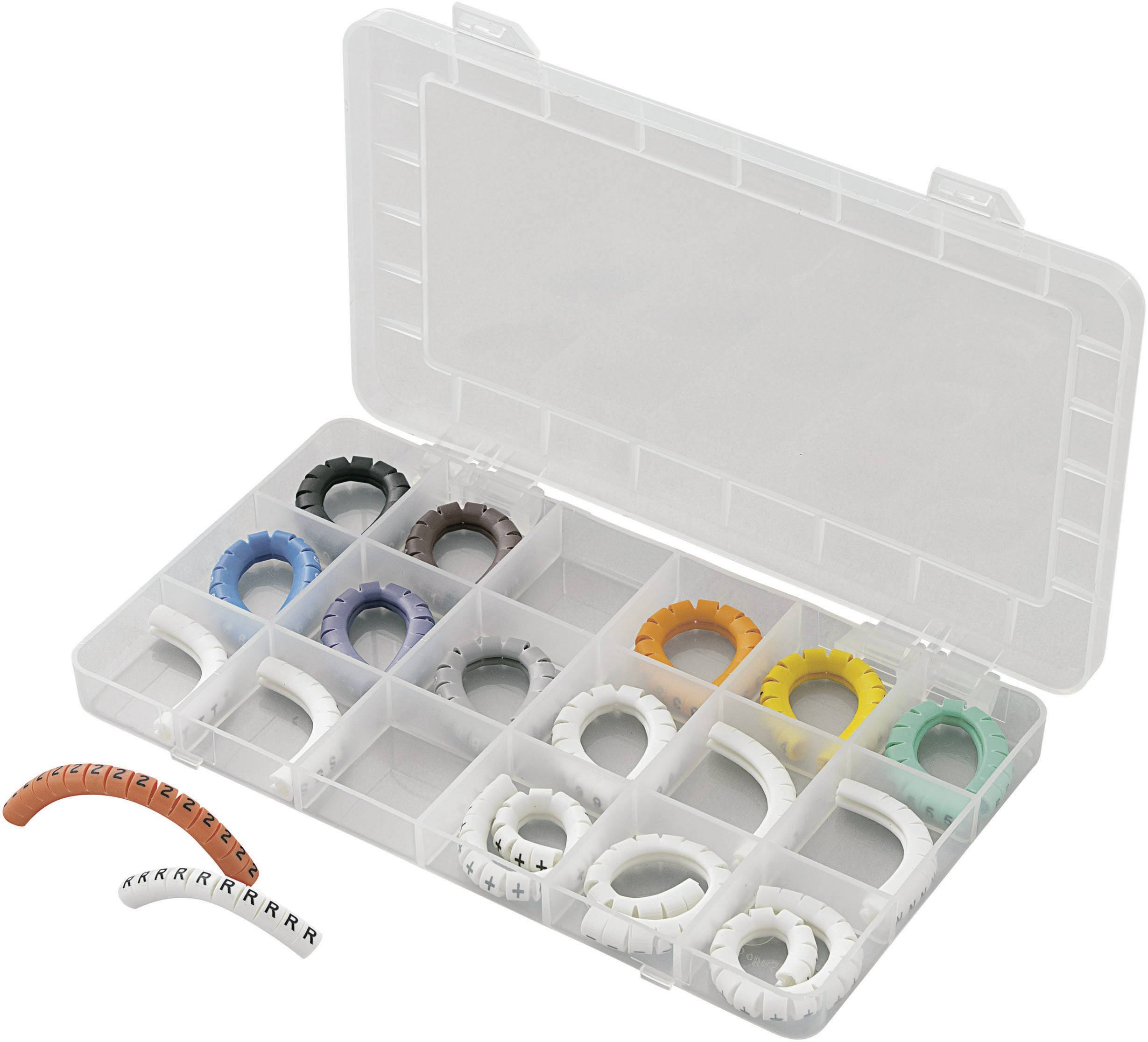 Une boîte en plastique ouverte avec des compartiments contient des bagues de marquage de câbles colorées. Quelques bagues sont posées à l'extérieur de la boîte.