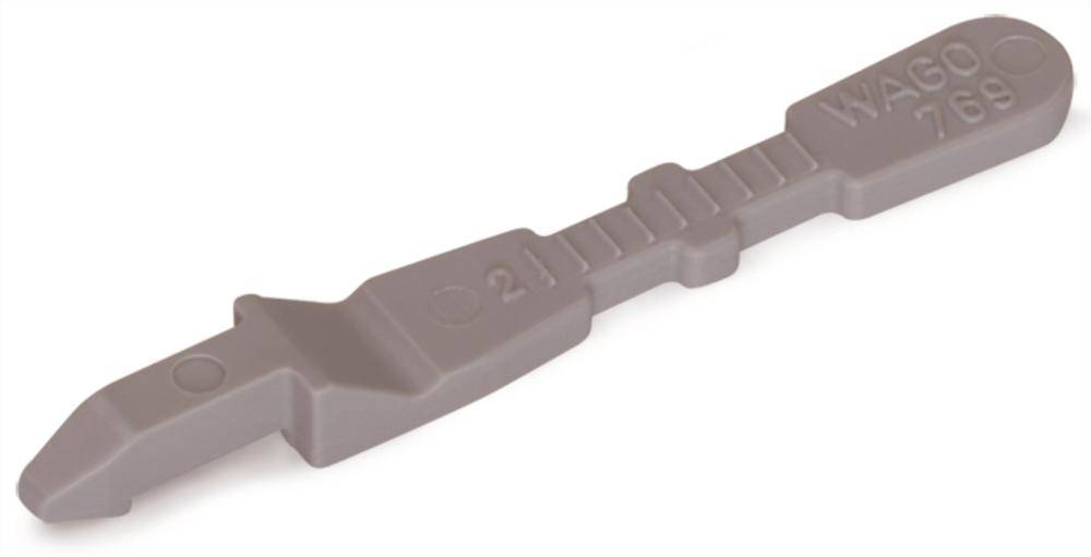 Un levier en plastique gris portant l'inscription 'WAGO 769', utilisé pour déverrouiller les bornes de connexion WAGO dans des applications électrotechniques.